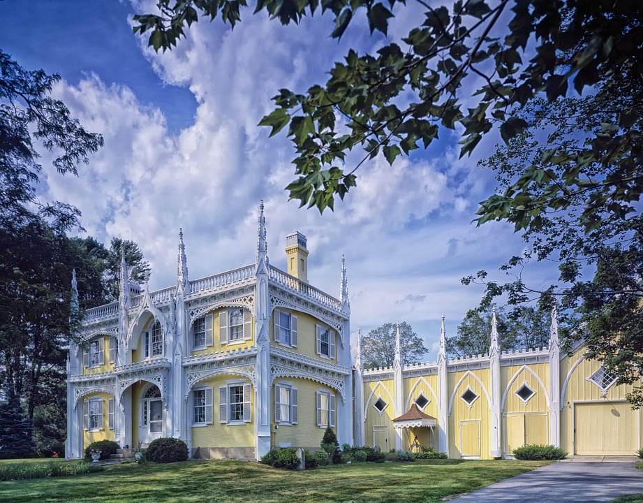 a castle looking home with a yellow exterior.